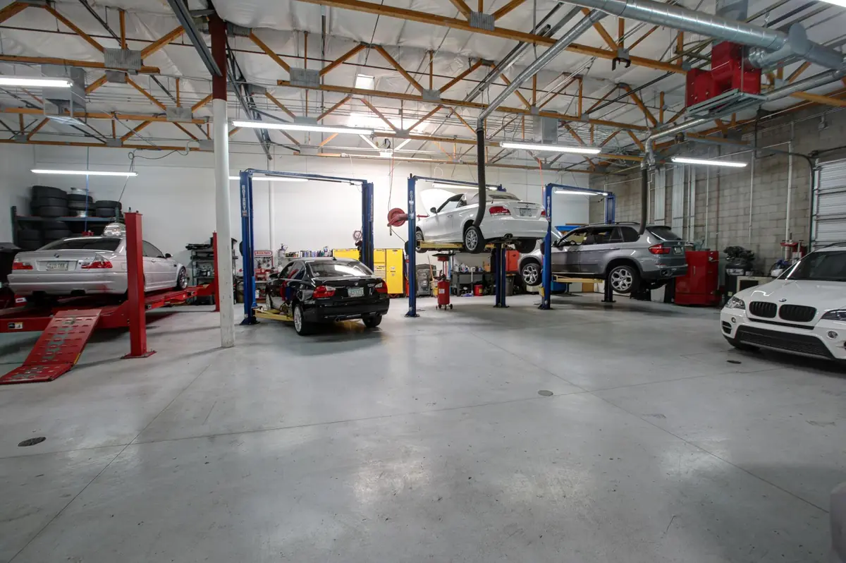 The Ultimate Auto Works shop floor with BMWs on lifts
